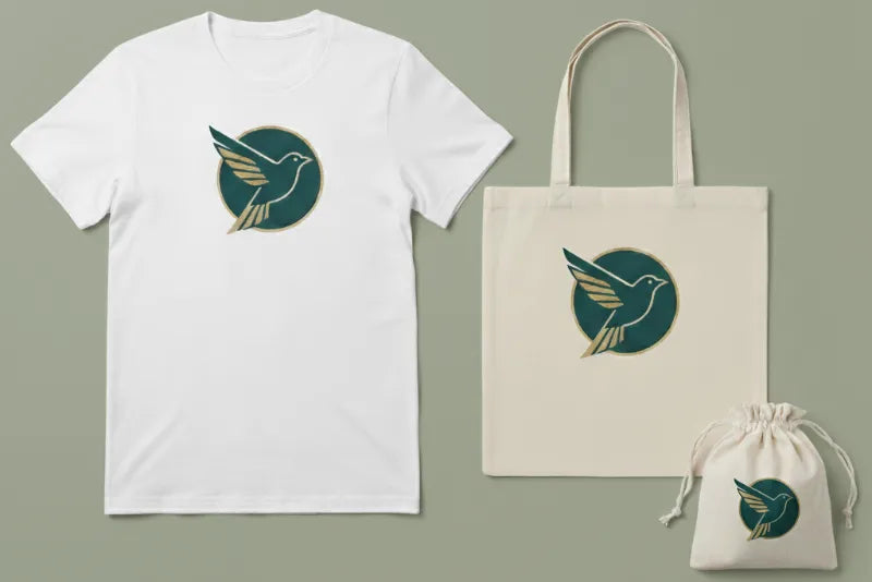 White t-shirt, beige tote bag, and white drawstring bag with a green and gold logo on a gray background