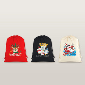 Three drawstring bags in red, black and natural with gathered tops and cords hanging down the sides, printed with Hello 2027 reindeer, Happy New Year 2027 penguins and 2027 Just Chillin snowman designs