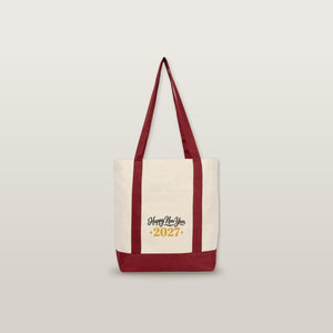 Studio photo of the burgundy strap canvas tote bag with a Happy New Year 2027 black and gold print
