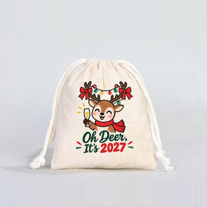 Real studio photo of a 4 x 5 inch natural cotton drawstring pouch with a natural cord, printed with the Oh Deer It's 2027 reindeer design