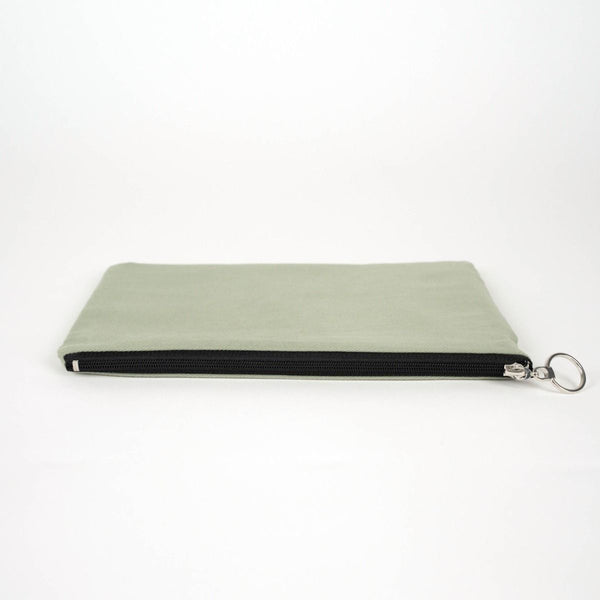 Light green pouch with a black zipper on a white background
