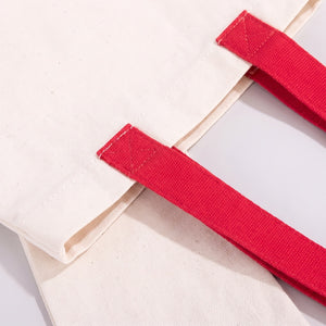 White martial arts gi with red belt on a light gray background