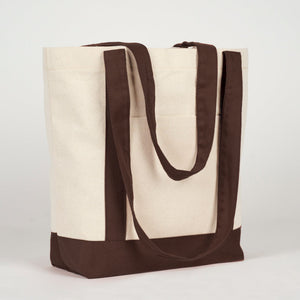 Three-quarter view of the canvas tote with dark brown handles - Pamusan.com
