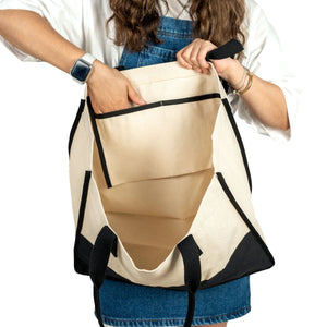Model holding black-bottomed canvas handbag – spacious and stylish tote
