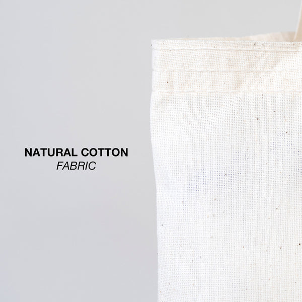 Close-up of natural cotton fabric with text 'NATURAL COTTON FABRIC' on a gray background
