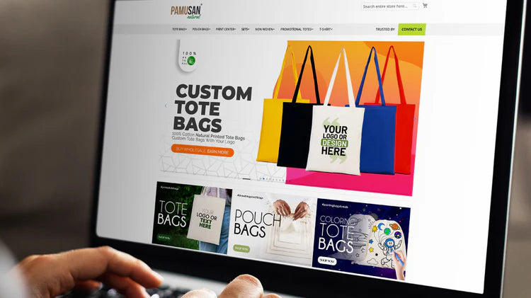 Person using a computer to browse a website for custom tote bags