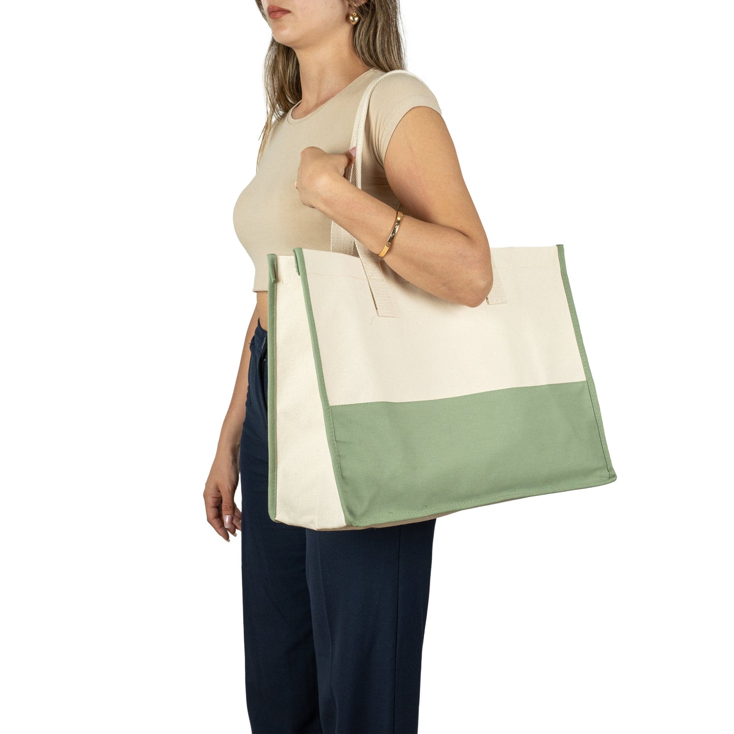 Woman carrying large beige and green canvas tote bag – perfect for shopping or travel