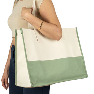 Woman carrying large beige and green canvas tote bag – perfect for shopping or travel