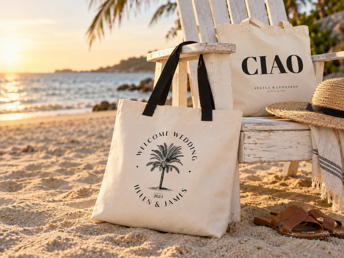 Oversized palm-tree wedding welcome tote leaning on an Adirondack chair on the sand at golden hour