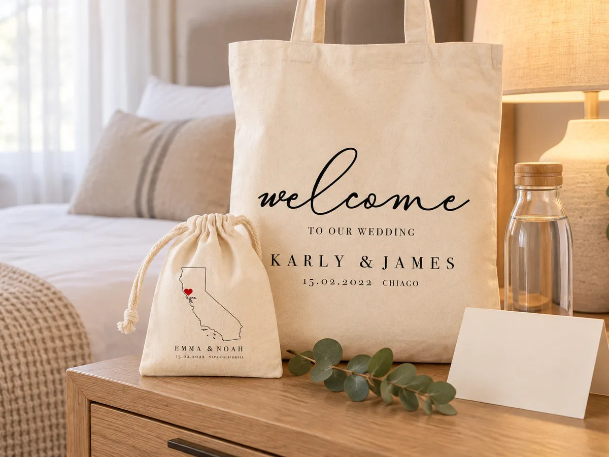 Personalized wedding welcome tote and favor pouch on a hotel nightstand with a water bottle and welcome card